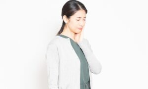 頬を抑える女性